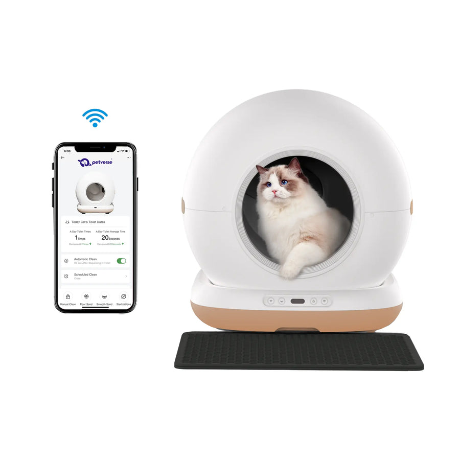 A cat sitting inside a round automatic cat litter box next to a smartphone showing its app controls.
