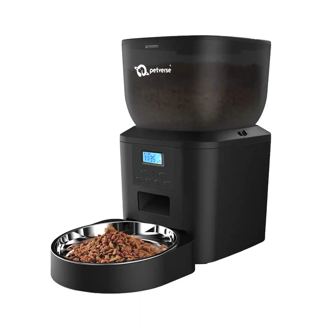 Black automatic pet feeder dispensing dry food into a stainless steel bowl with a digital display.
