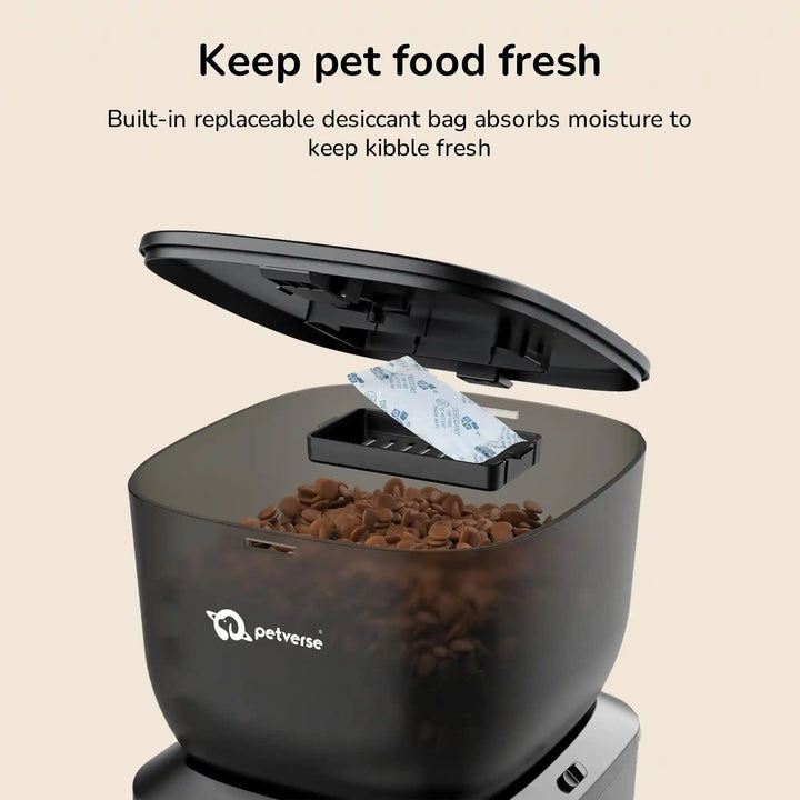 Black Automatic pet feeder with open lid showing a desiccant packet inside to keep kibble fresh 