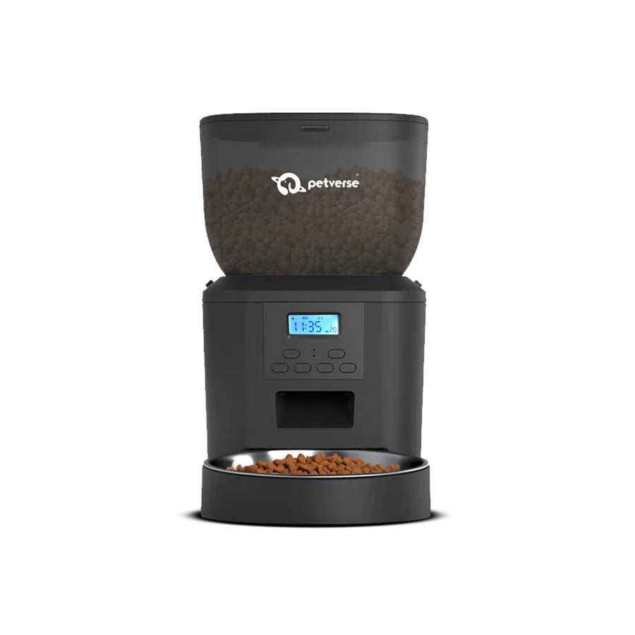 Black automatic pet feeder dispensing dry food into a stainless steel bowl with a digital display.