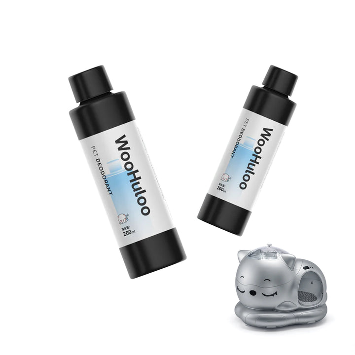 Two black‑capped WooHuluo pet deodorant bottles with blue labels floating above a silver smart cat litter box.