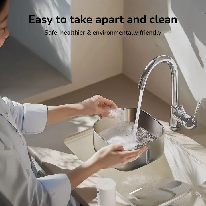Person washing removable stainless pet water fountain bowl under faucet ”