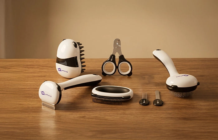 Set of grooming tools including a hairbrush, Nail Clipper, Deshedding Tool and other hair care items 