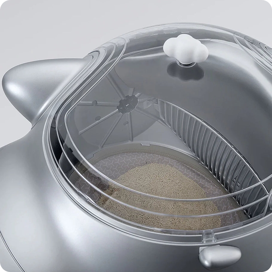 Top view of a silver smart cat litter box showing the interior compartment.