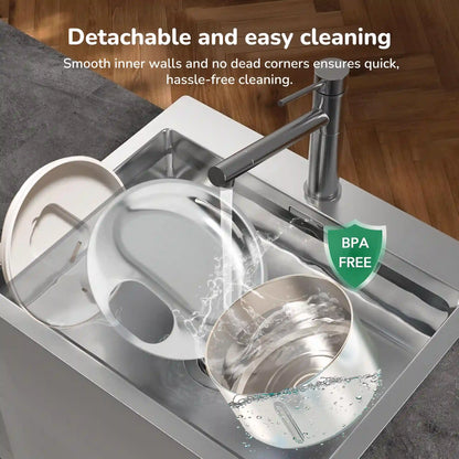 Detachable pet water fountain parts being rinsed in a kitchen sink