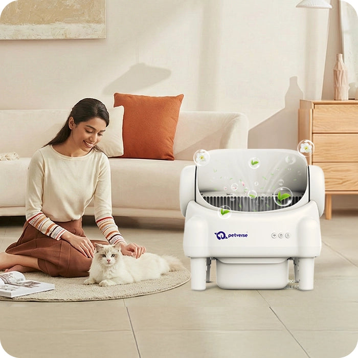 Pet parent smiling beside a modern cat litter box placed in a living room, showing a clean home and relaxed cat