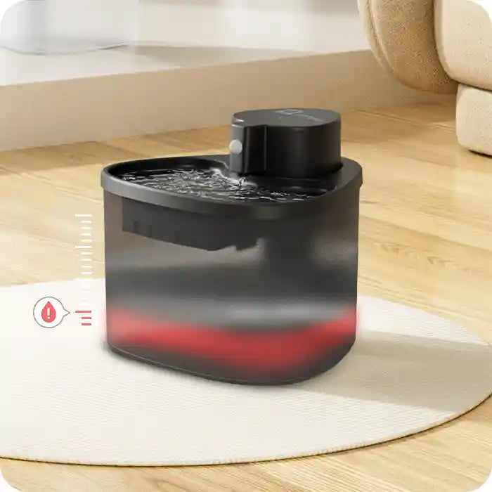 Black pet water fountain on floor with flowing water and red status indicator at base