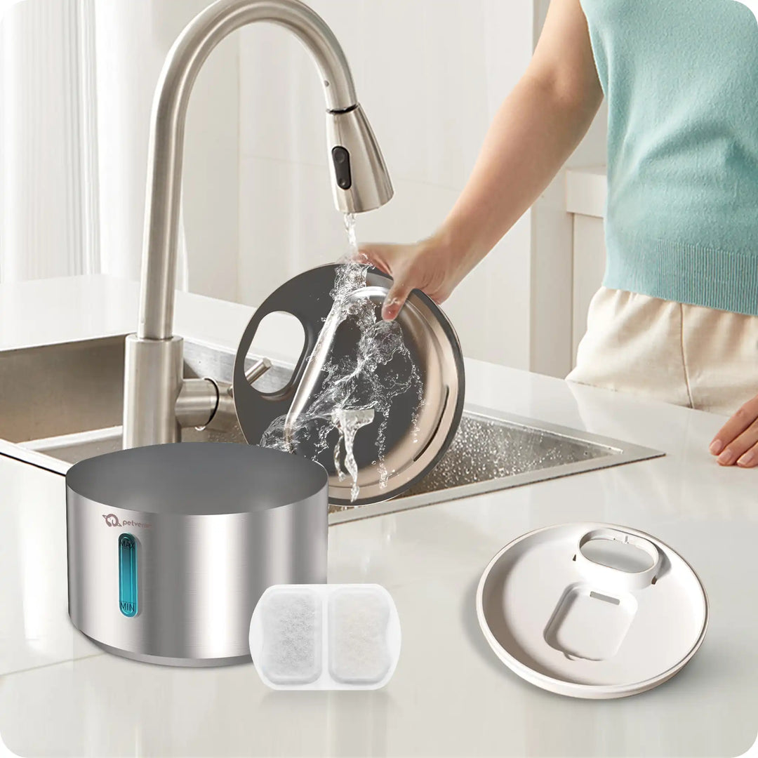Person washing dishes in a kitchen with a modern faucet and stainless steel pot.