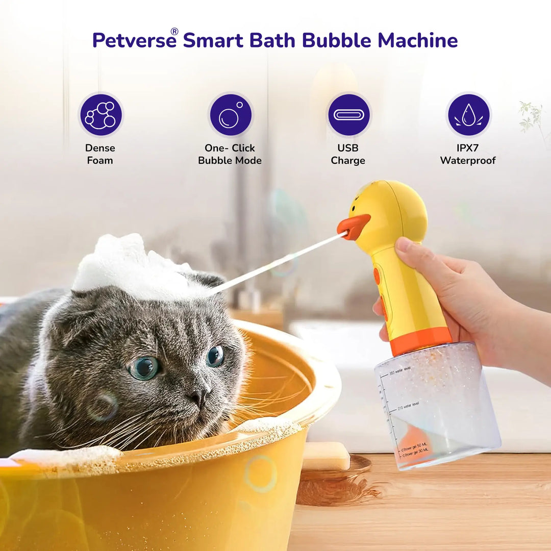 Cat in tub with handheld yellow bubble bath machine spraying foam.