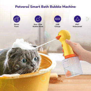 Cat in tub with handheld yellow bubble bath machine spraying foam.